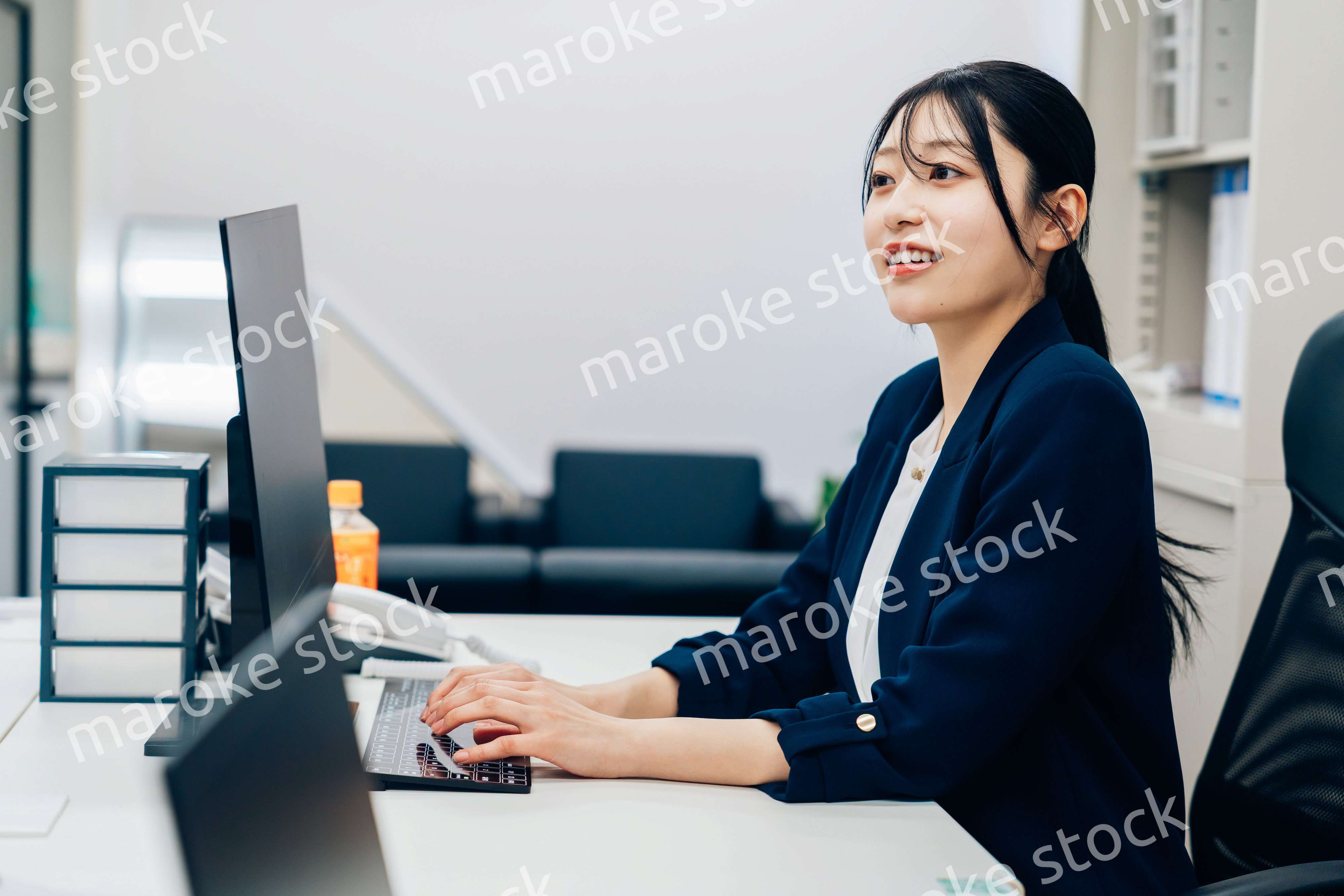 オフィスカジュアルで仕事をする若い女性