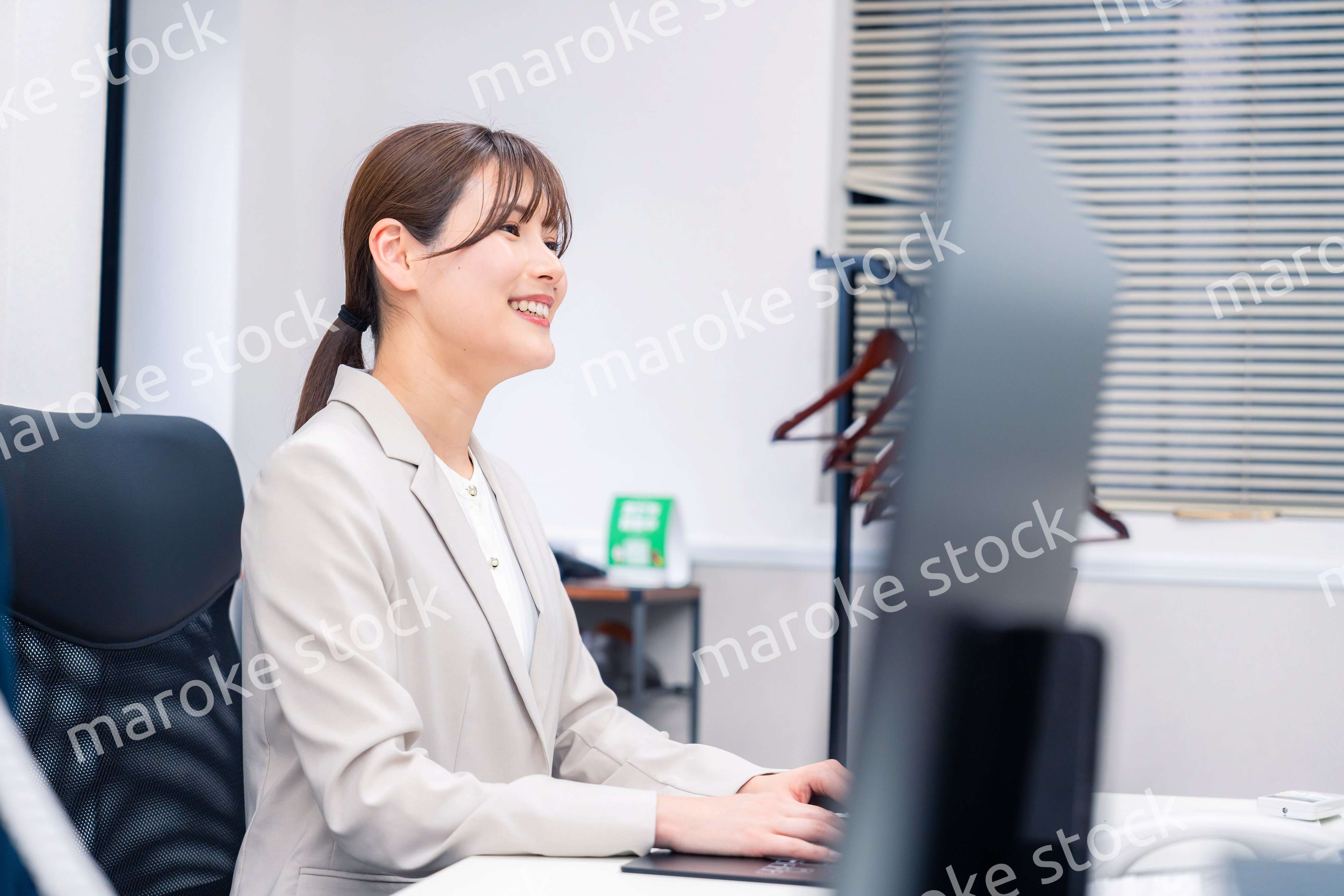 役所でデスクワークをする公務員の若い女性