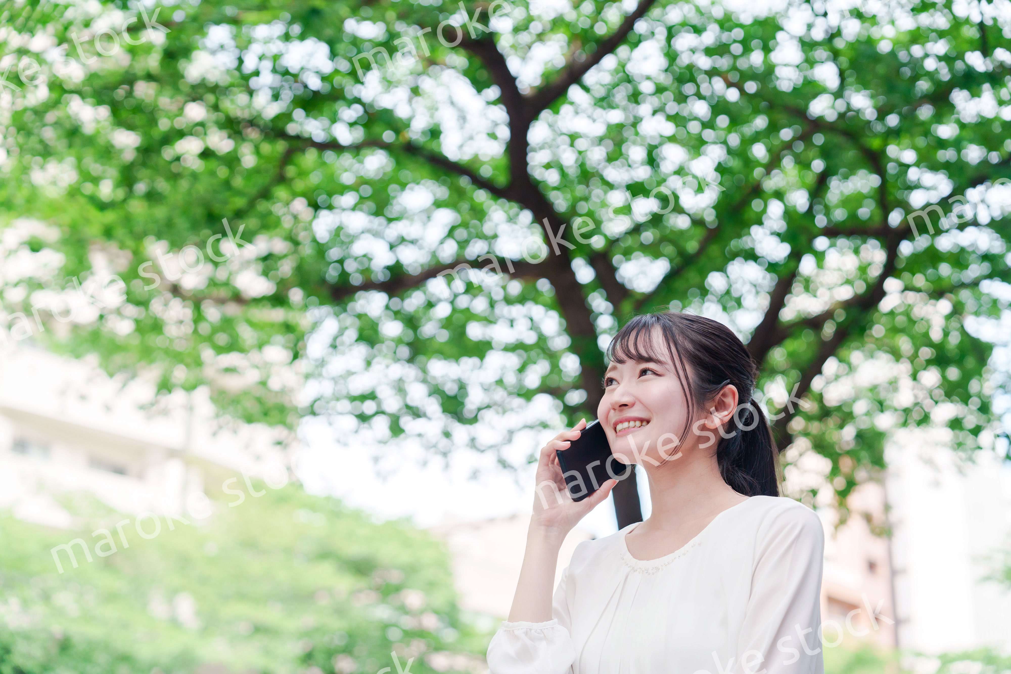 外で通話をする若い女性