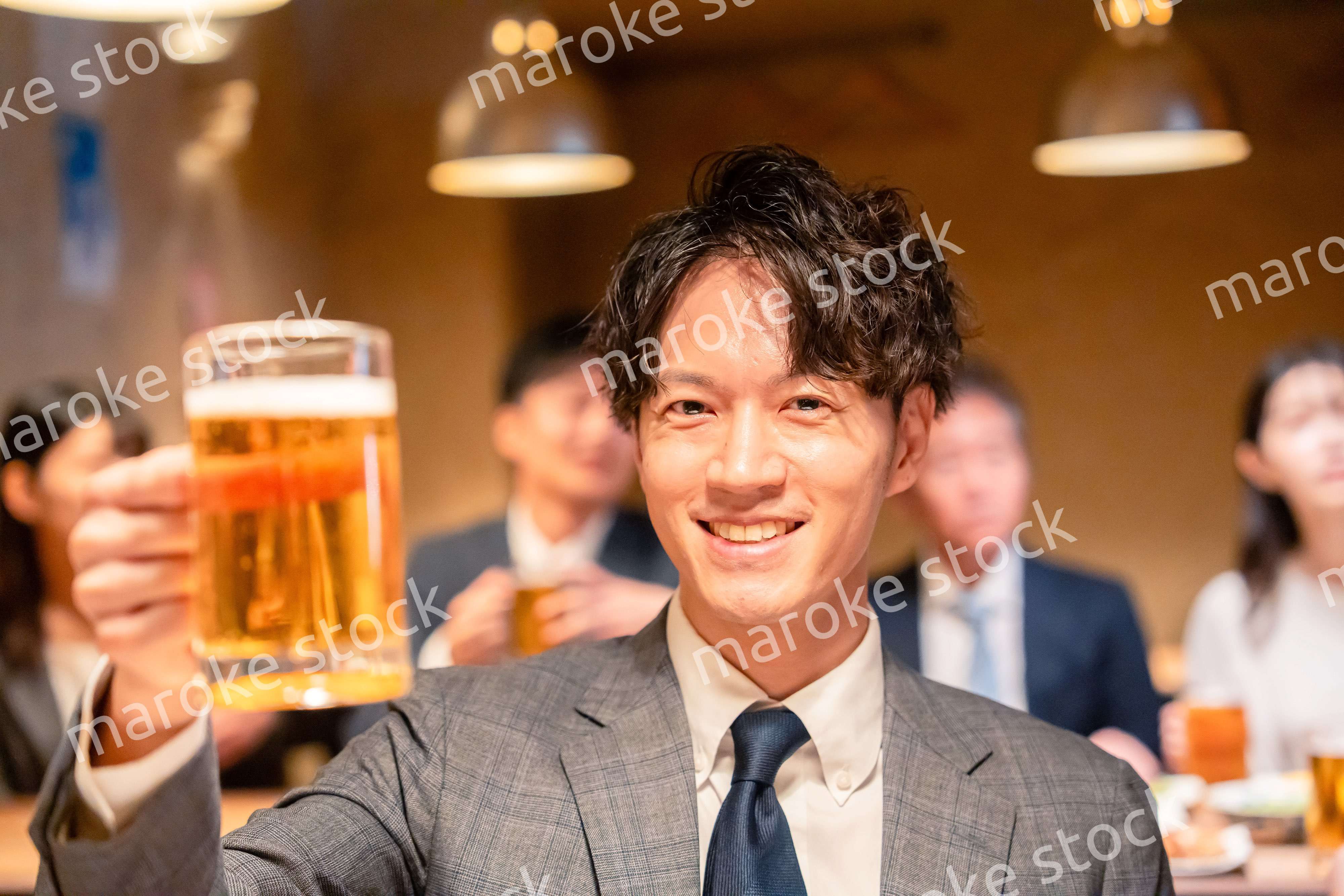 居酒屋でビールの乾杯をするサラリーマンの男性