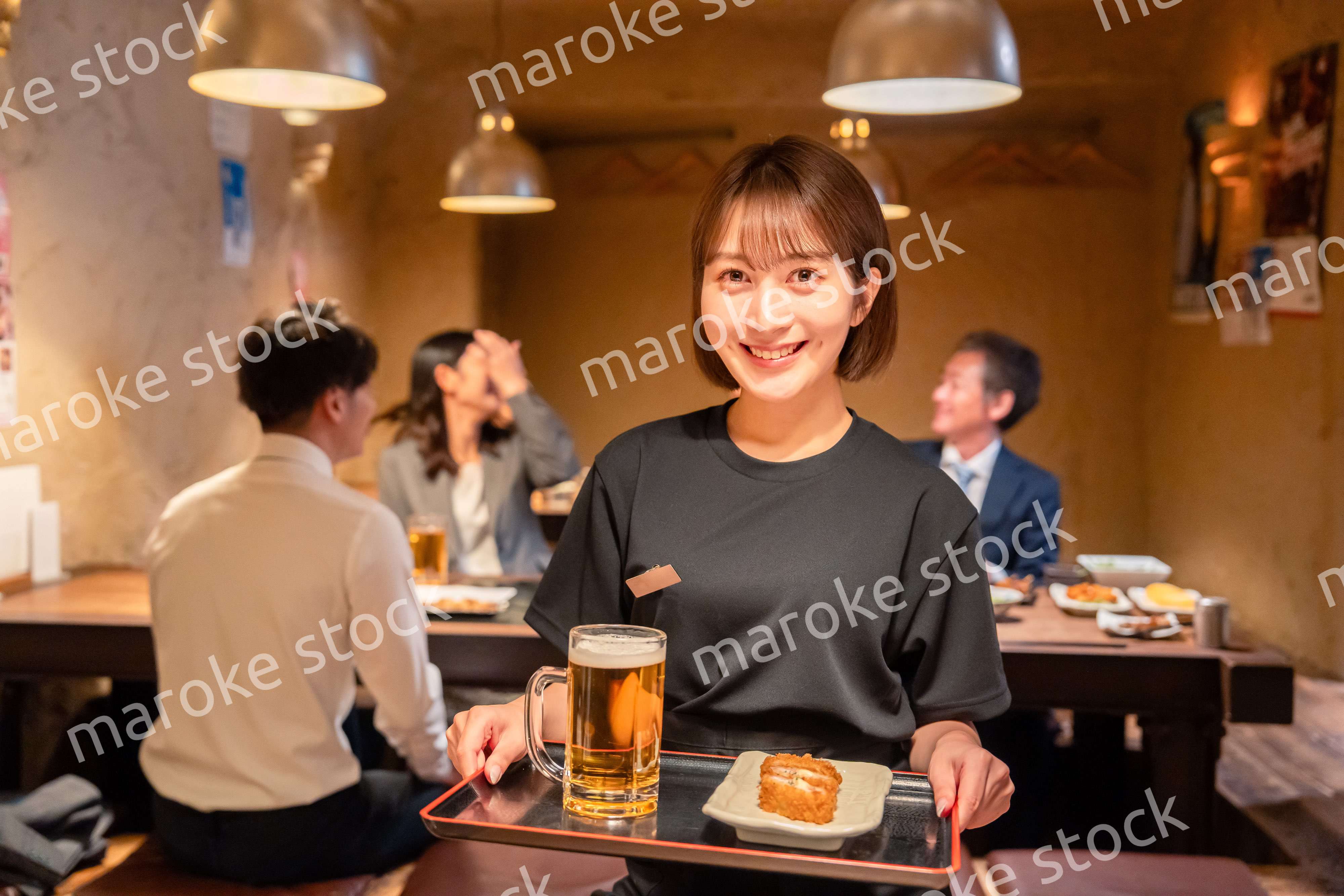 居酒屋のホールで働く若い女性