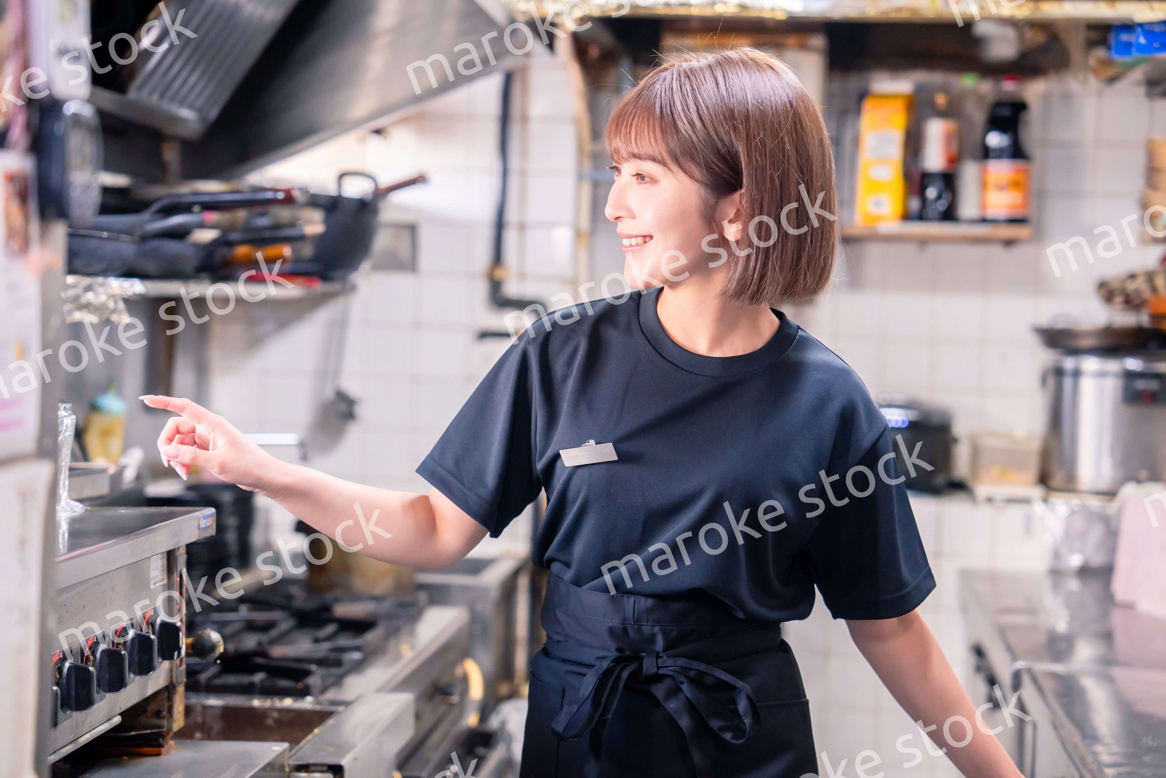 居酒屋の厨房で働くキッチンスタッフの女性