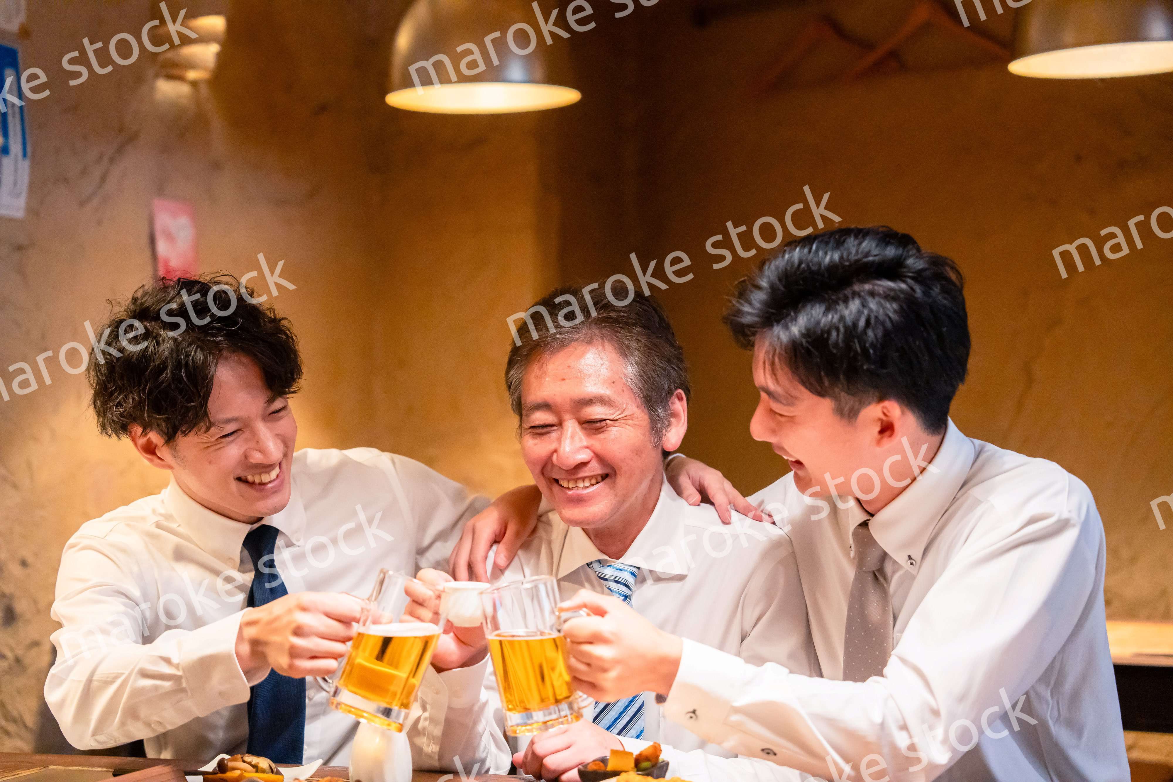 上司と肩を組みながら居酒屋で飲むサラリーマン