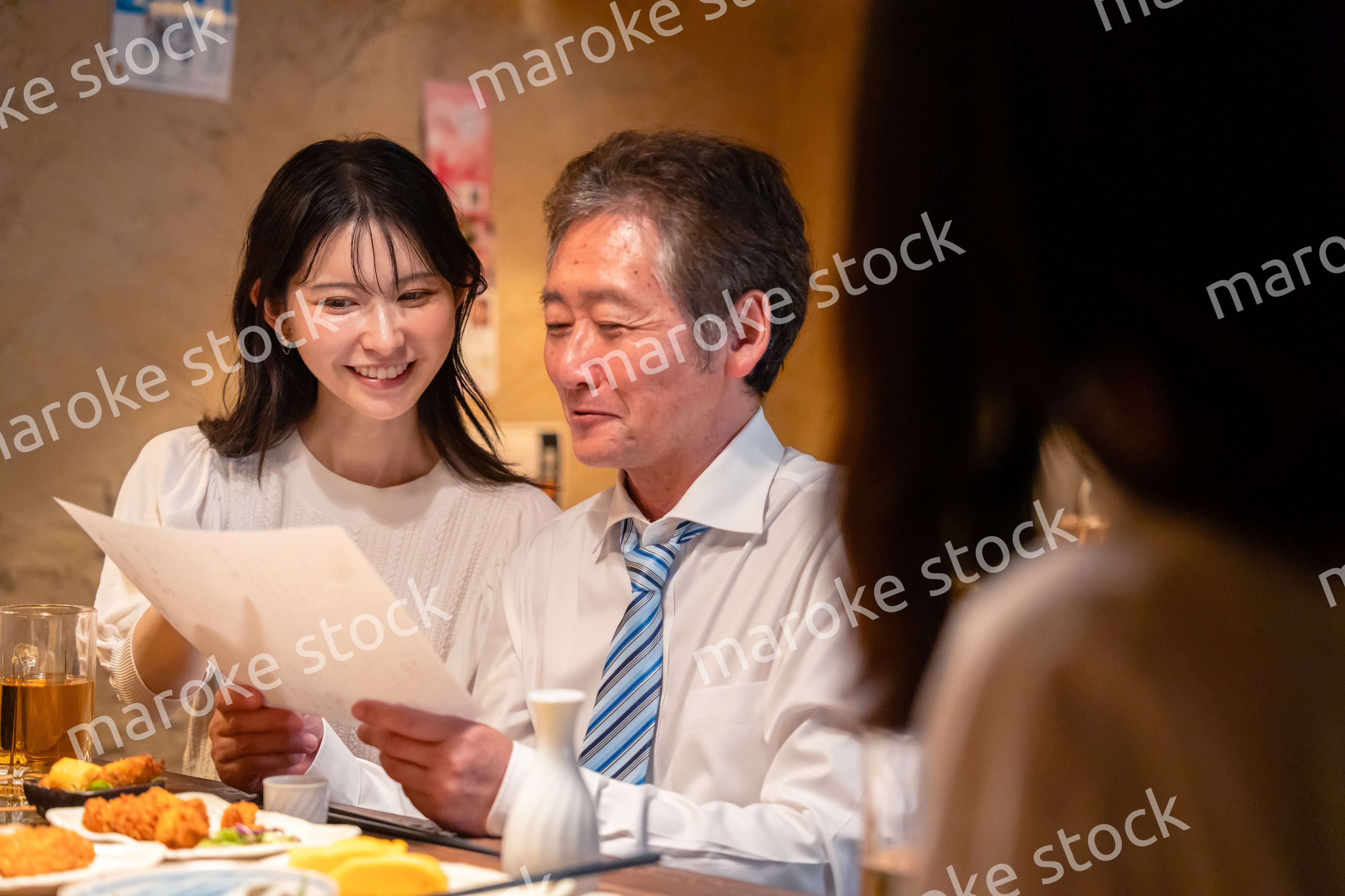 若い女性と二人でお酒を飲む男性