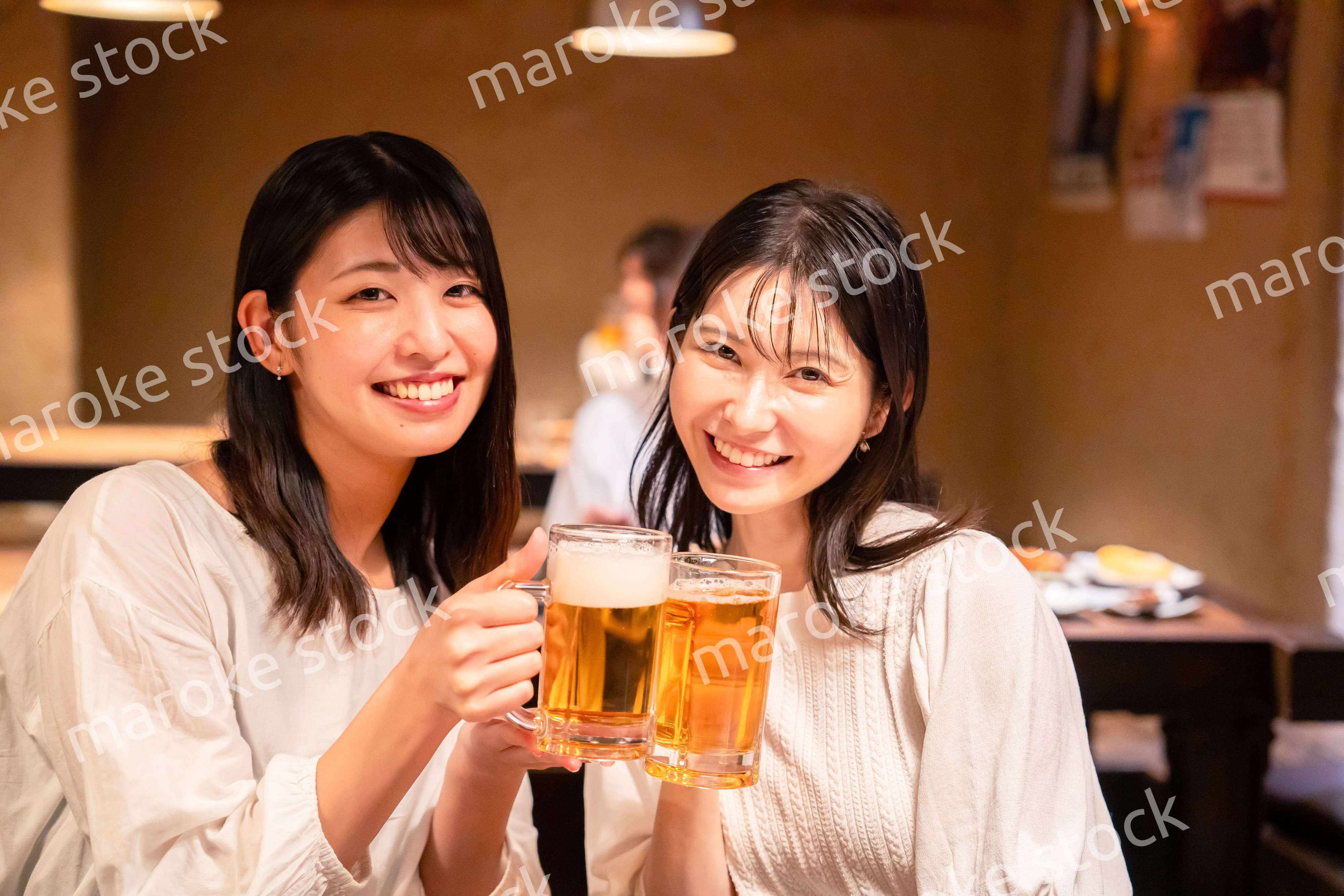 居酒屋で女子会をする二人の女性