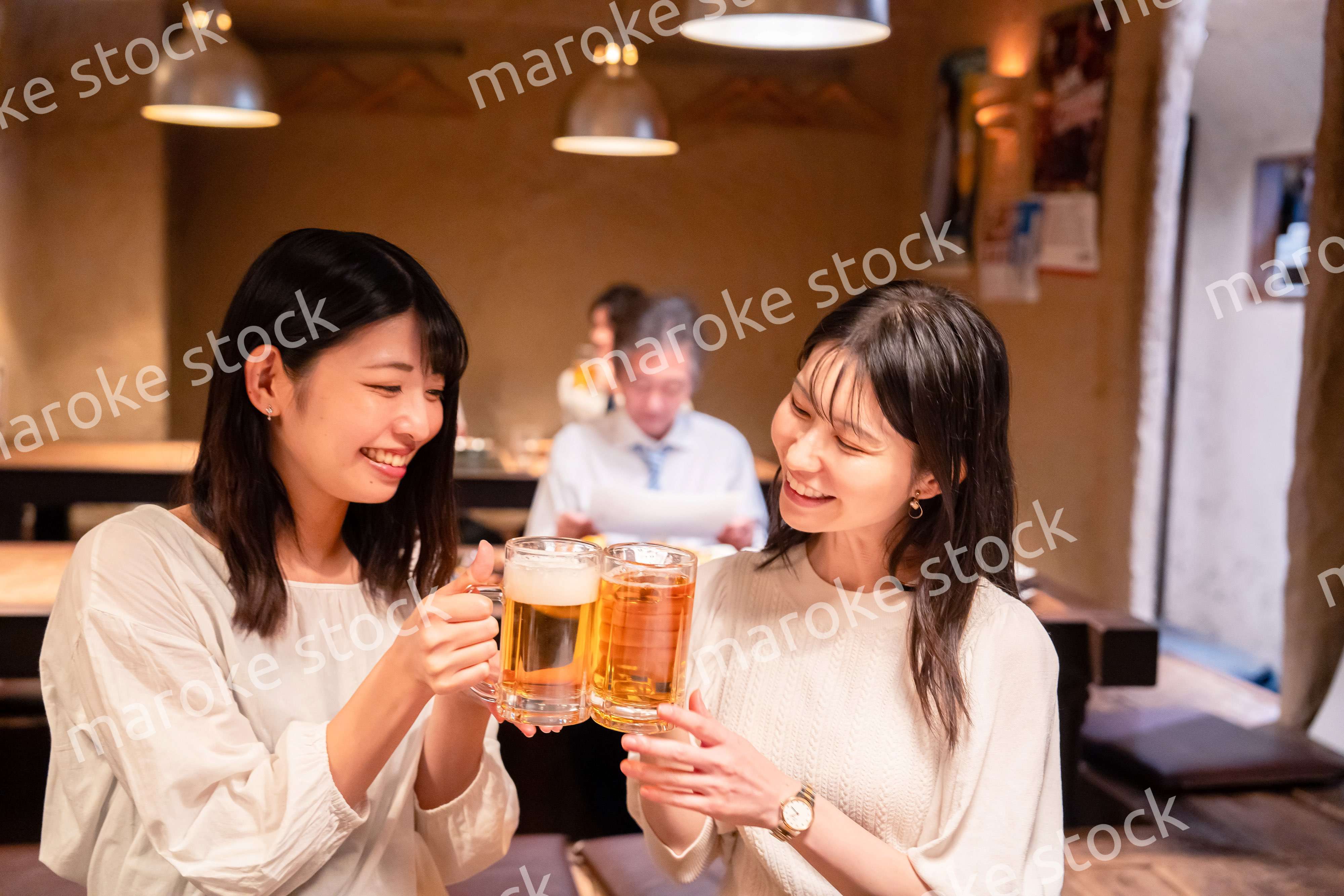 居酒屋で女子会をする二人の女性