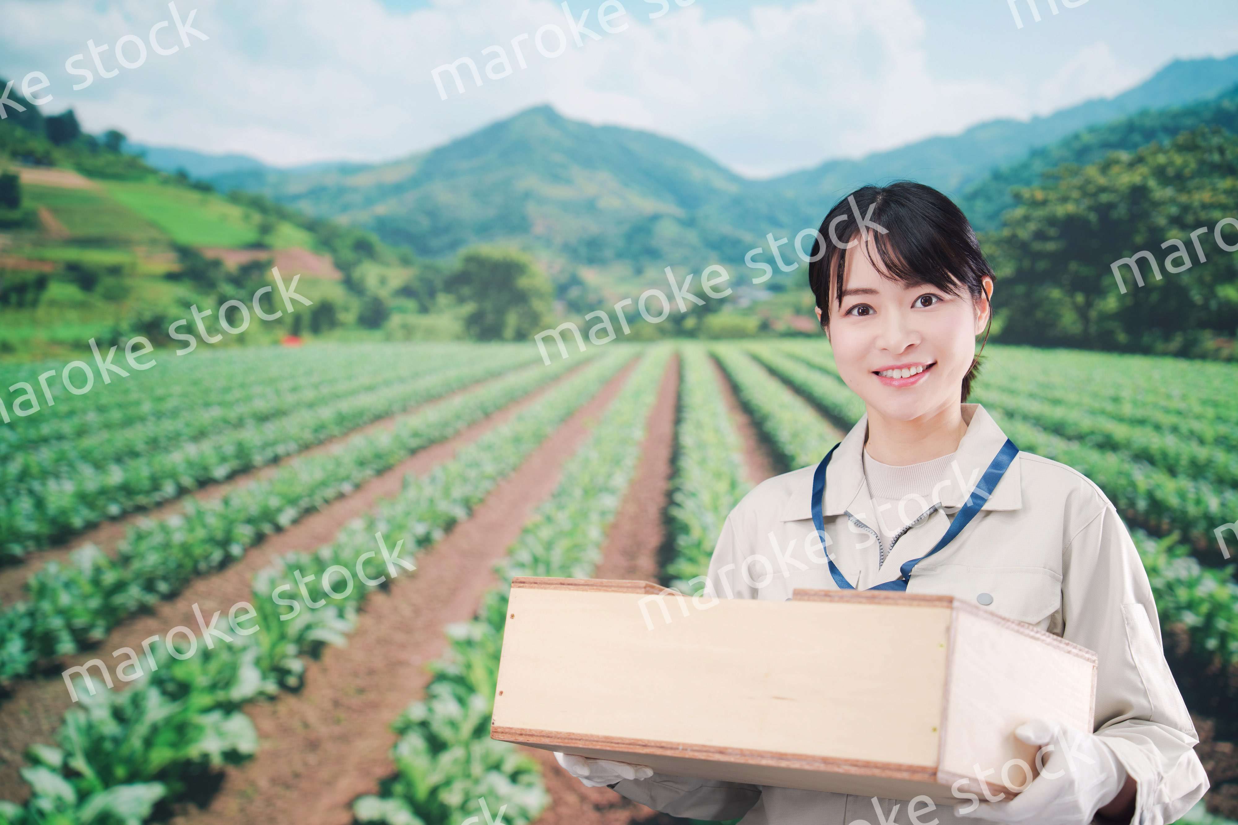 箱を運搬する農家の若い女性