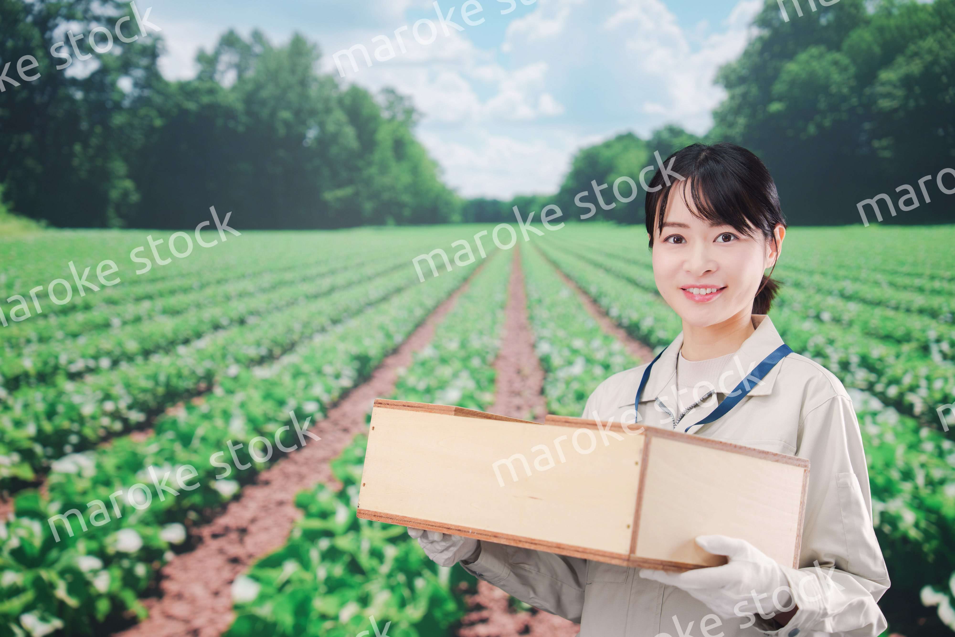 広い農園で働く農家の若い女性