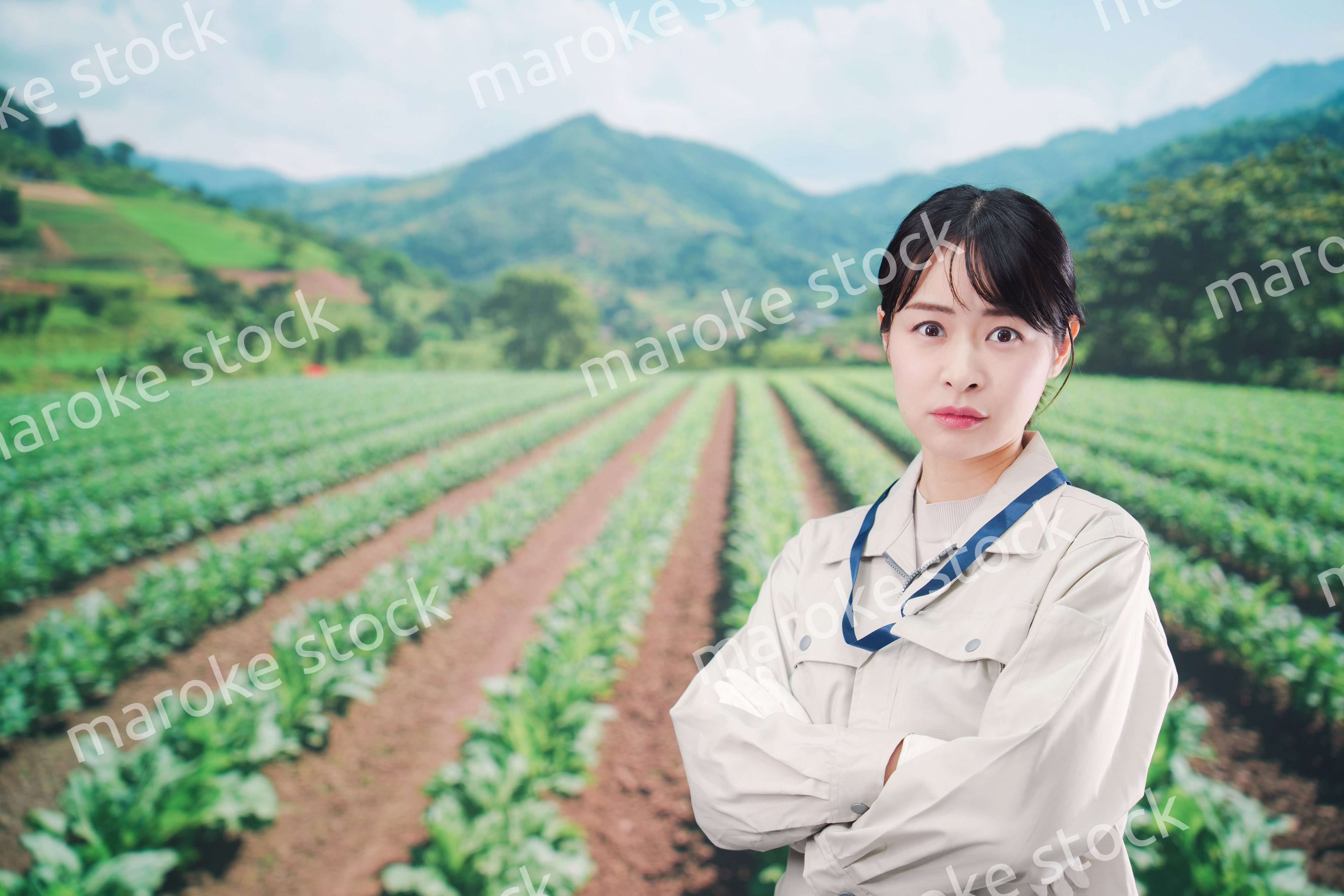 畑で悩む農家の若い女性