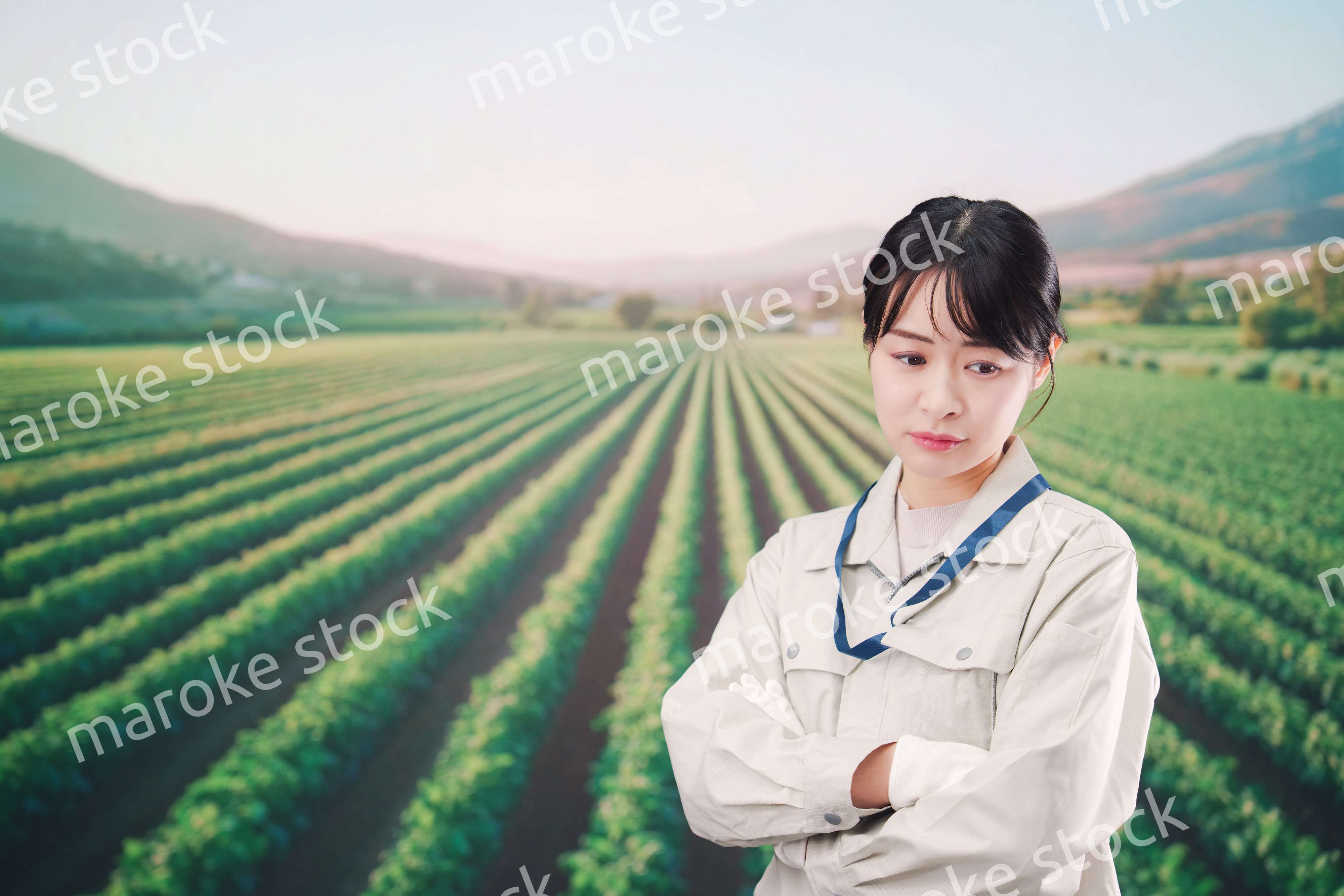 畑で悩む農家の若い女性