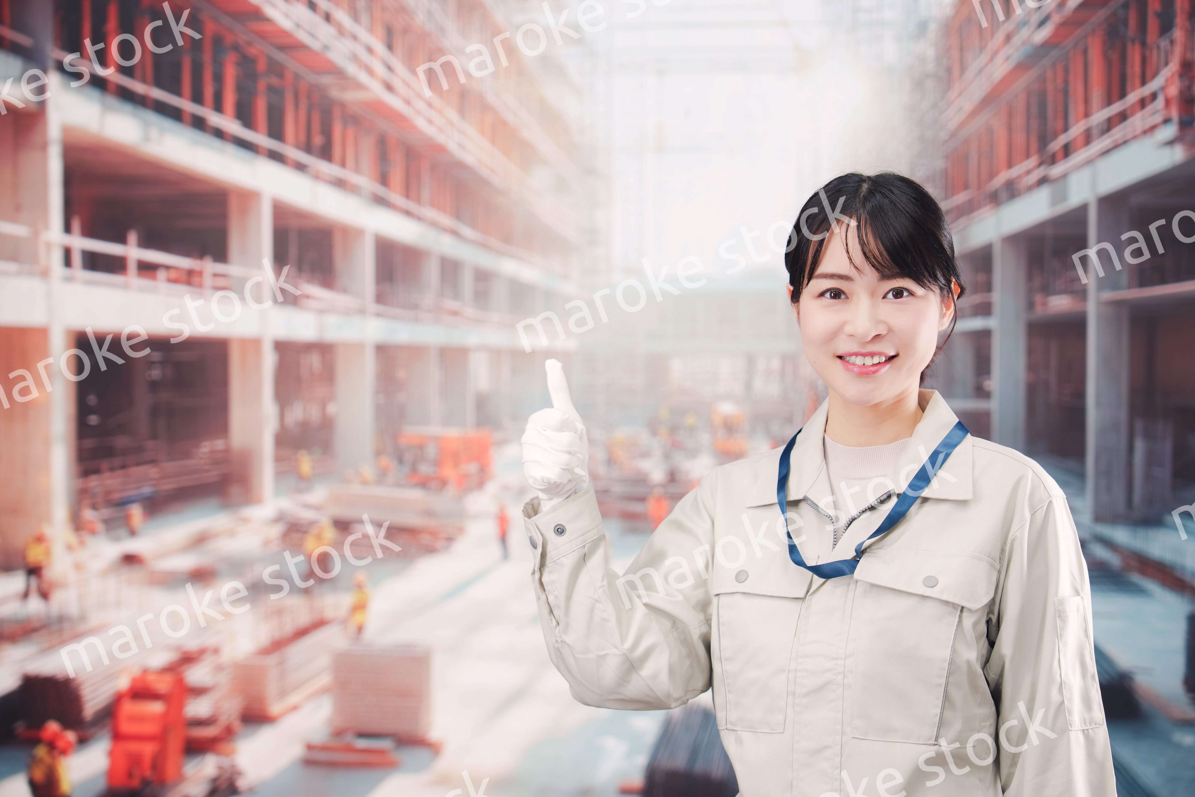 ビルの建築現場で働く作業着を着た若い女性