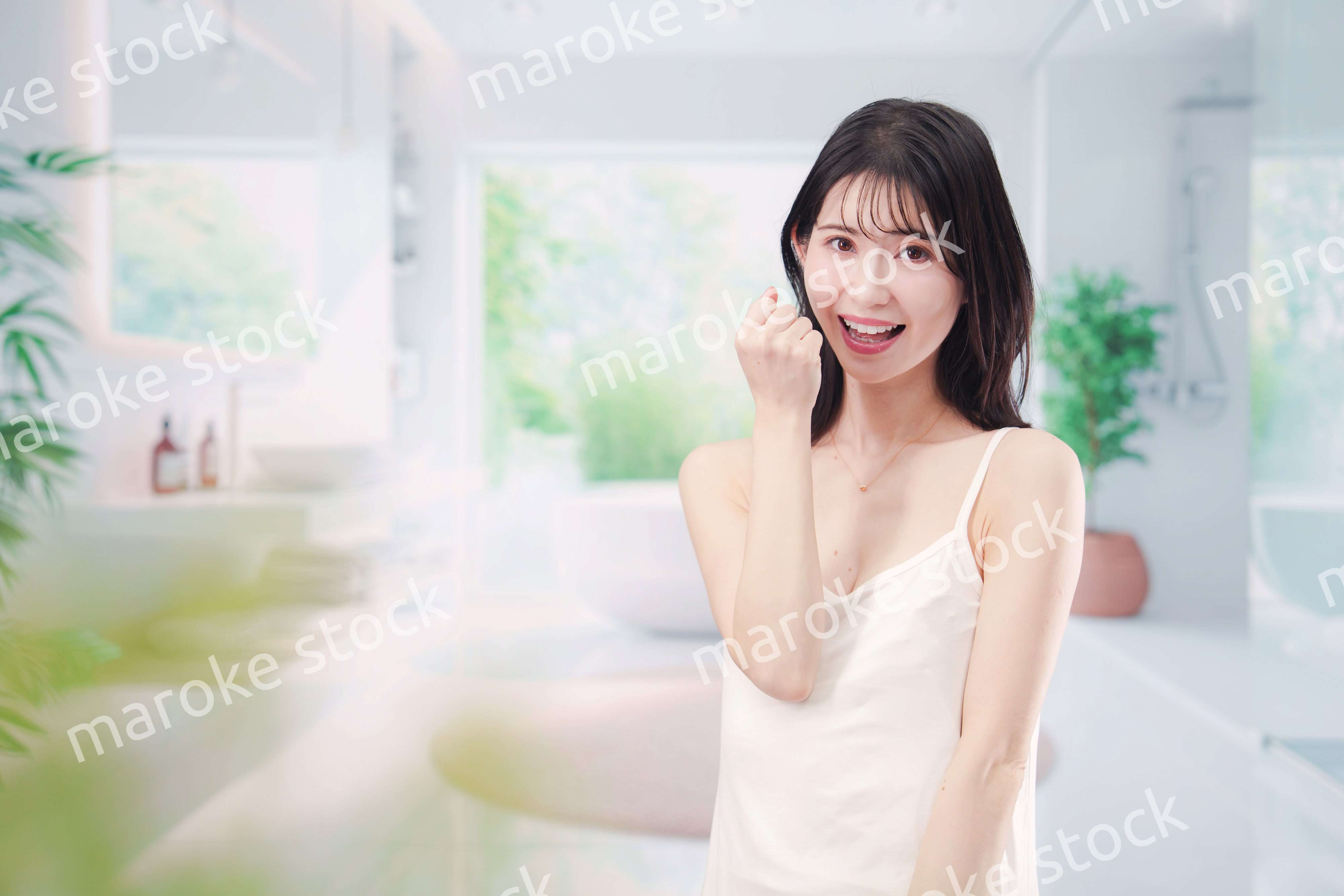 バスルームでスキンケアをする若い女性