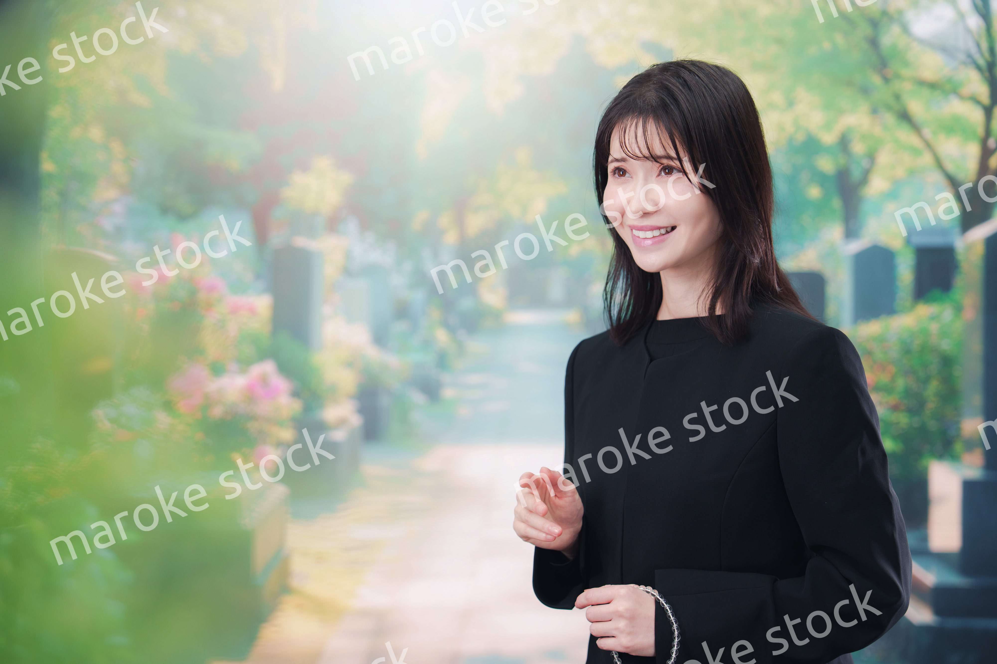 喪服を着てお墓参りをする女性