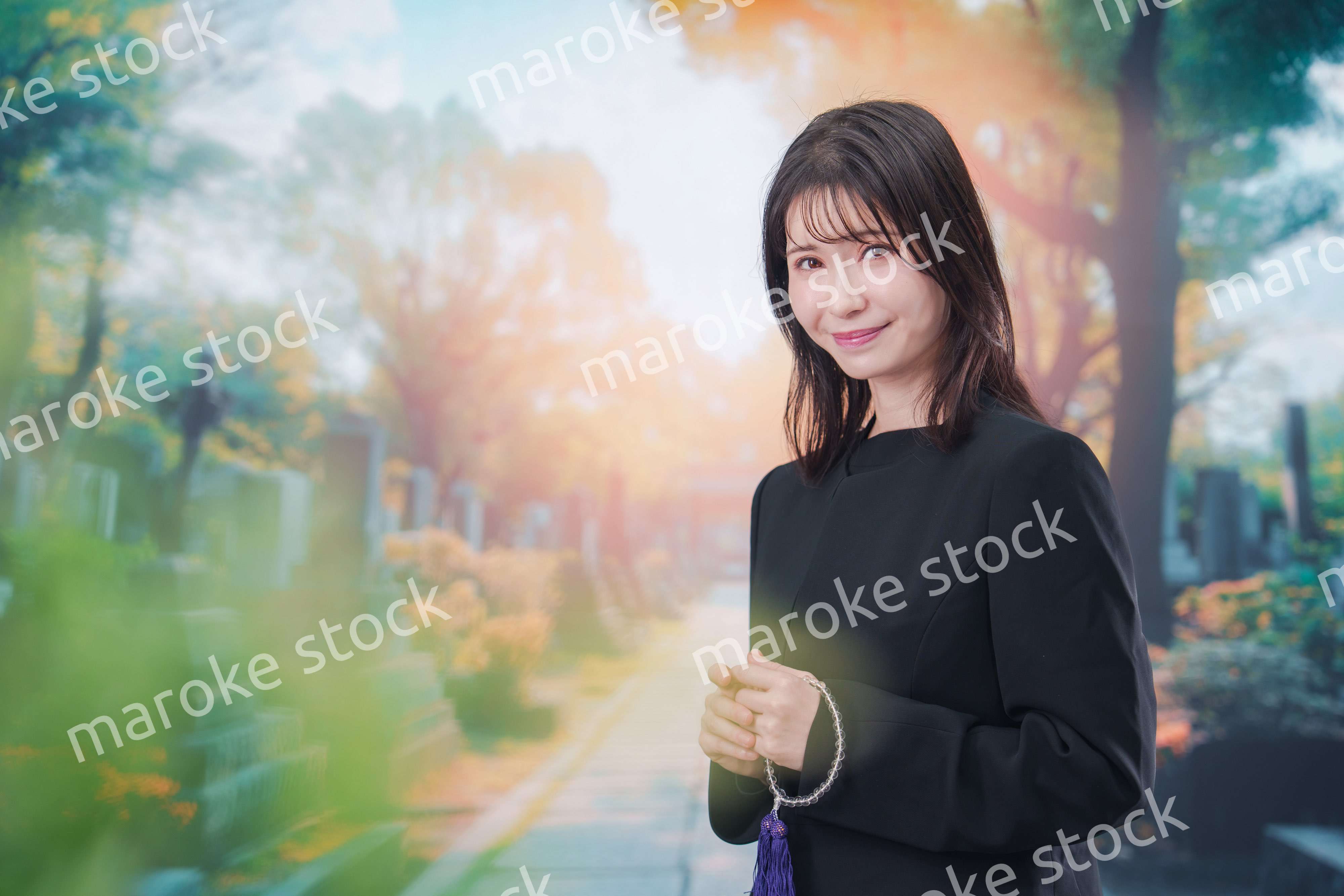 喪服を着てお墓参りをする女性