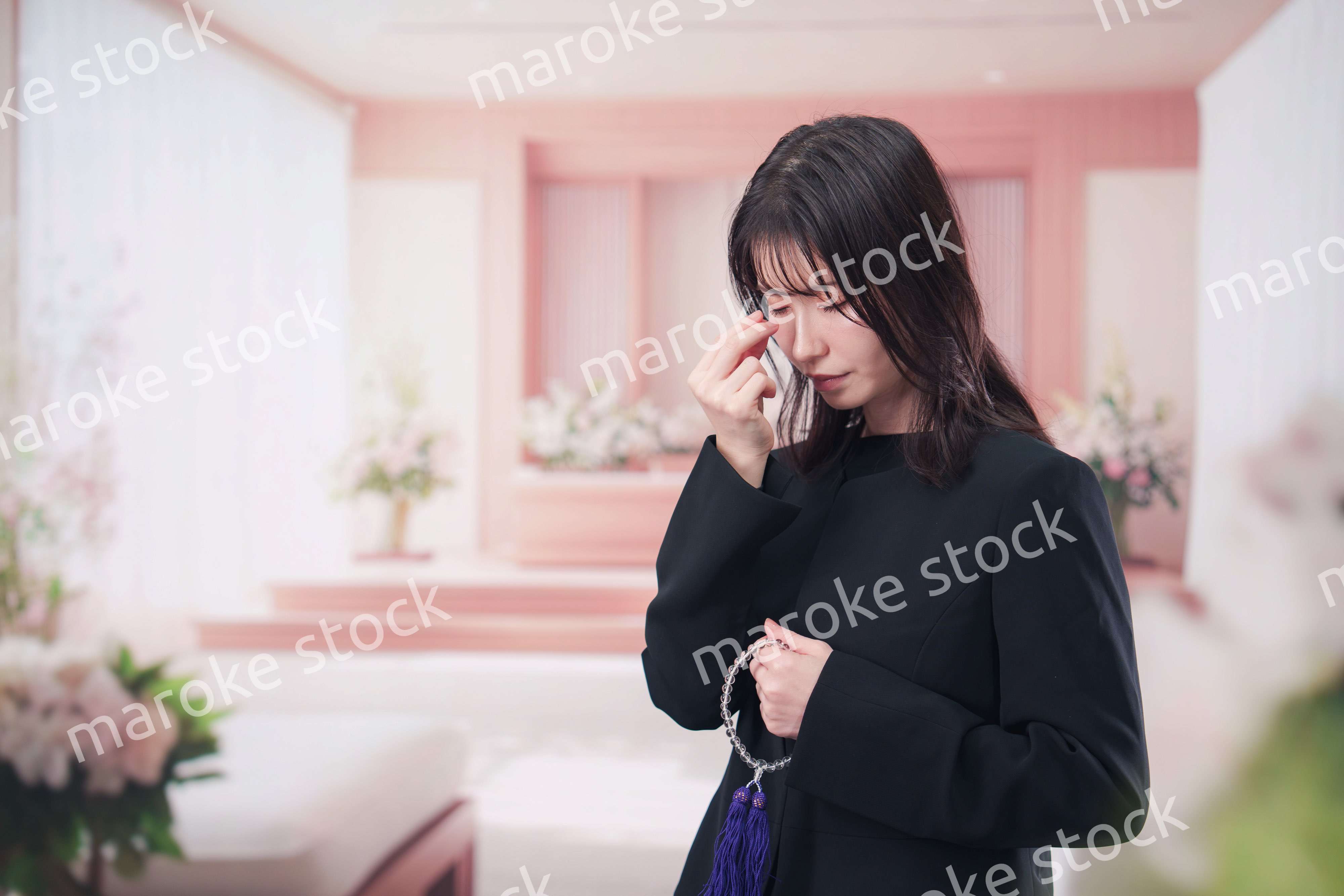 お葬式でお焼香をする女性の参列者