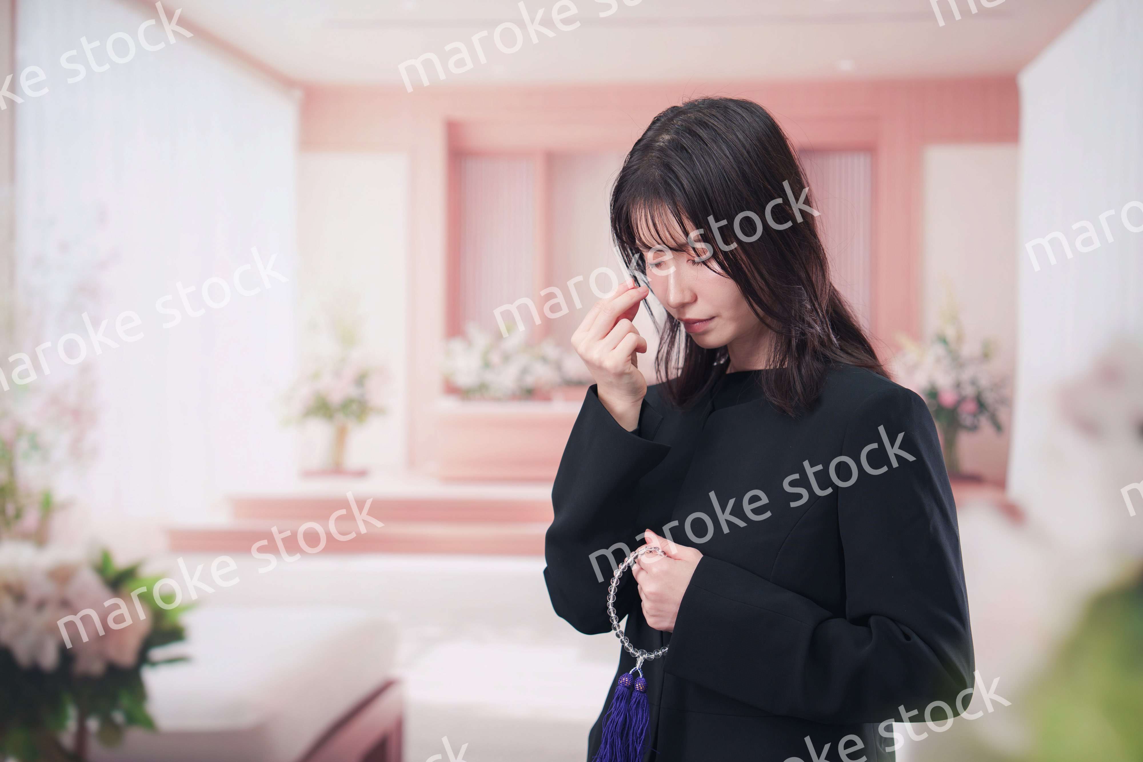 お葬式でお焼香をする女性の参列者