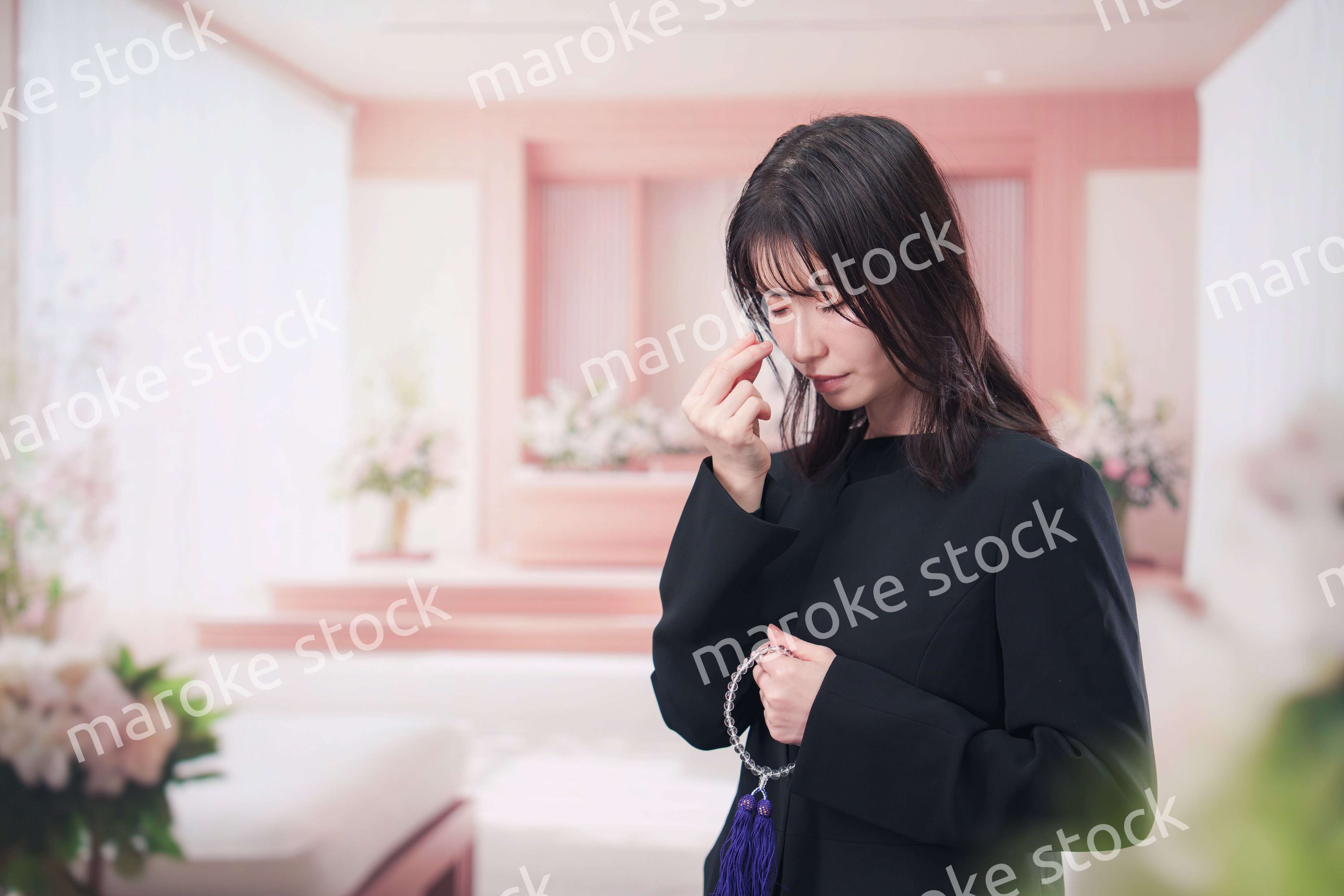 お葬式でお焼香をする女性の参列者