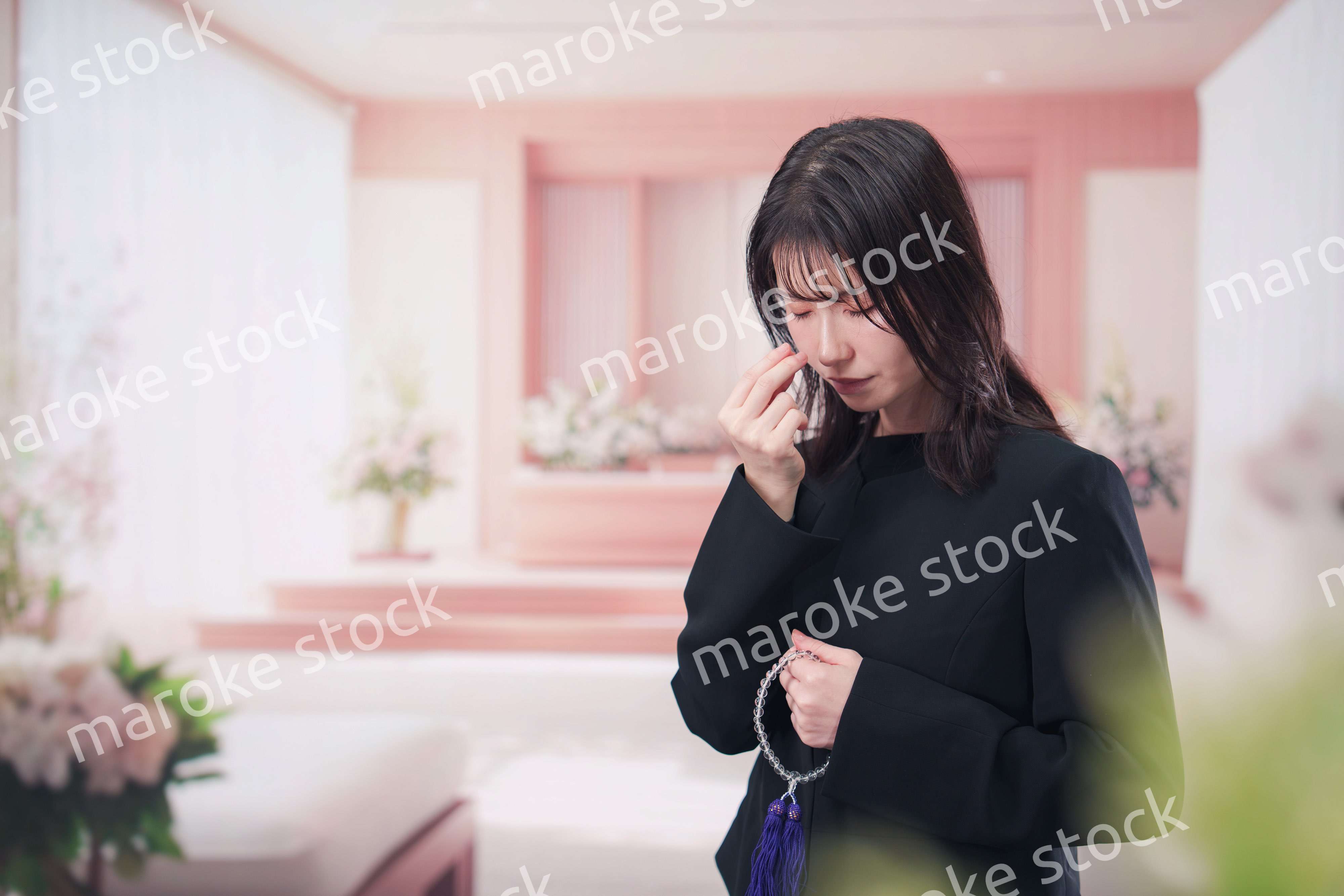 お葬式でお焼香をする女性の参列者