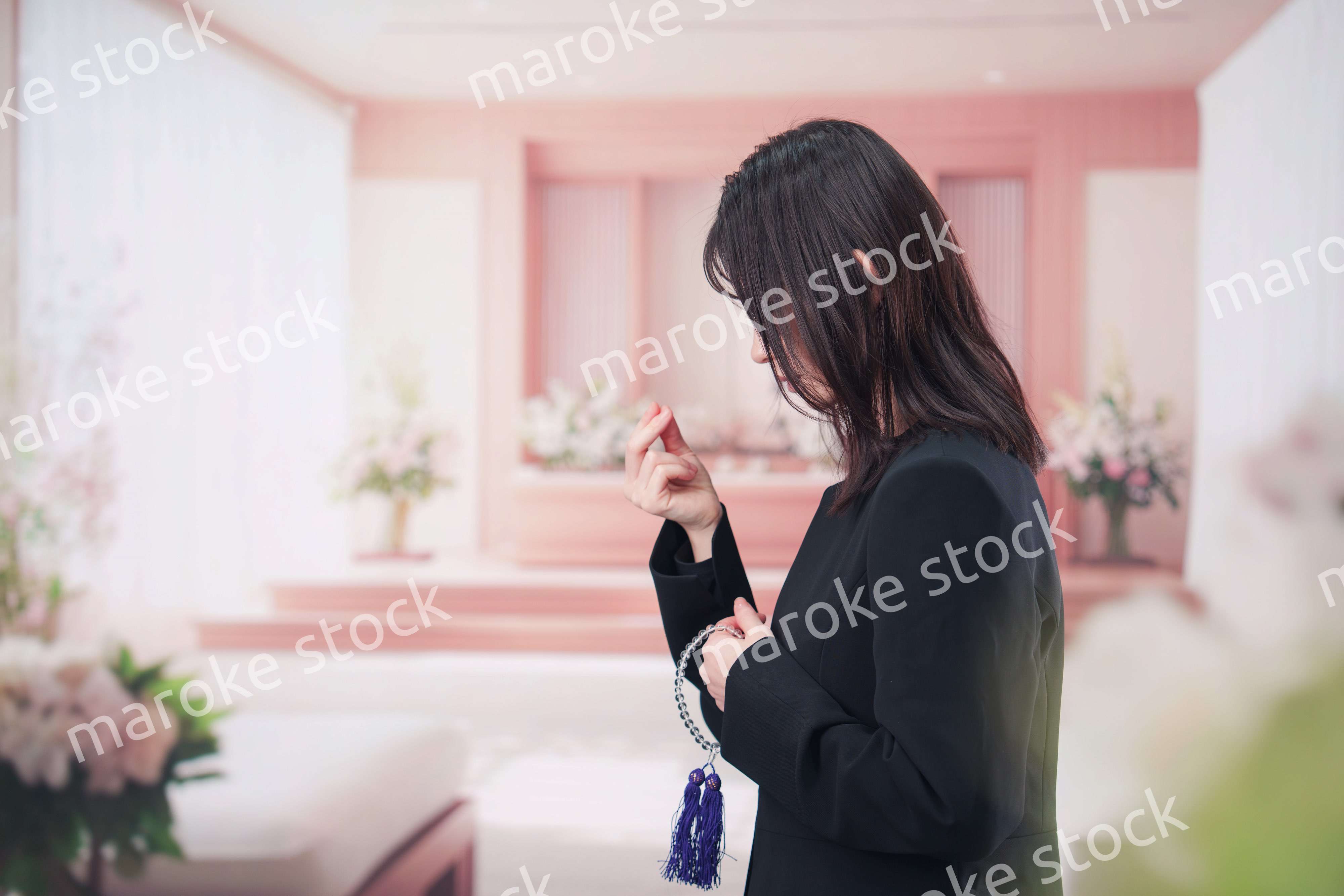 お葬式でお焼香をする女性の参列者