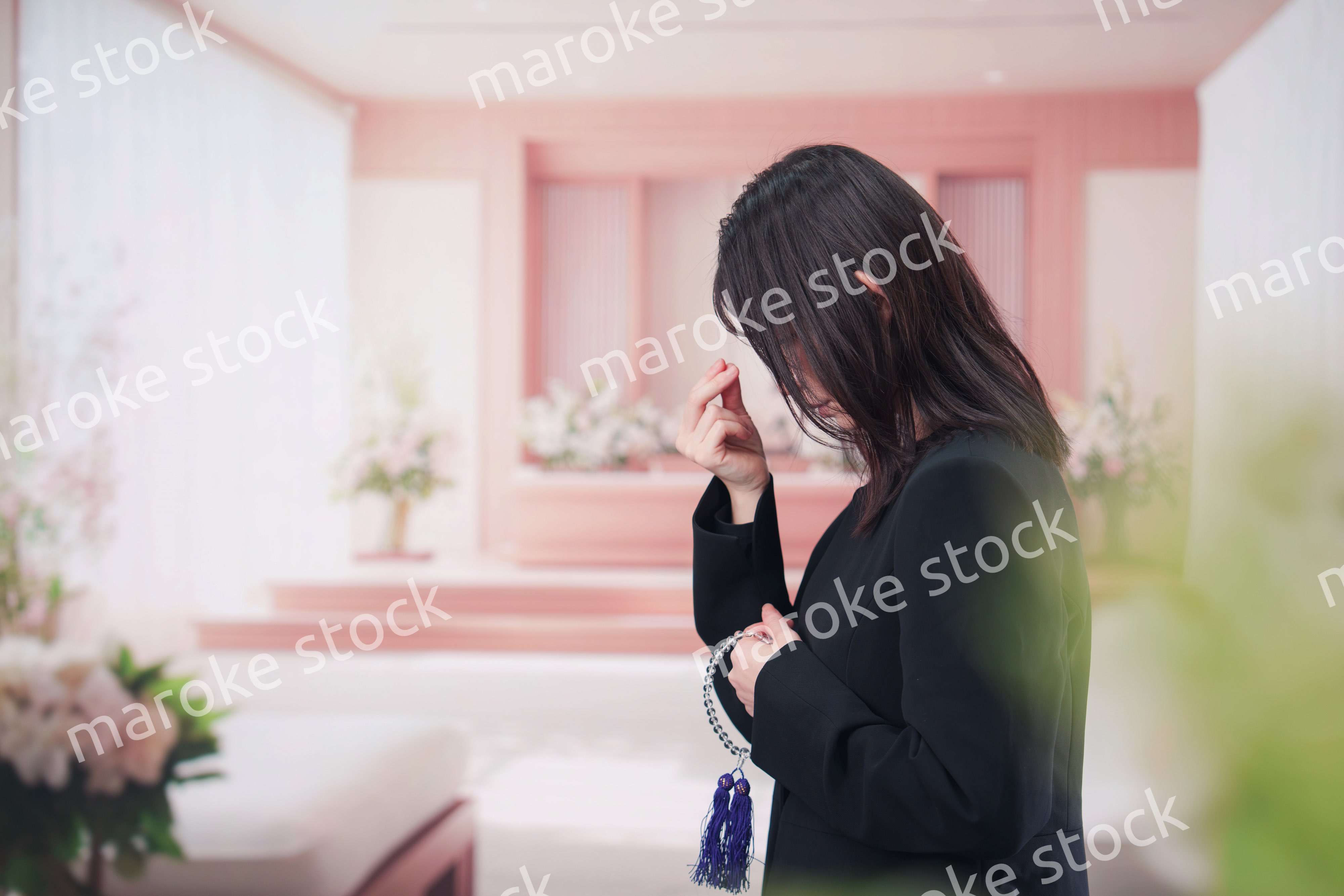 お葬式でお焼香をする女性の参列者