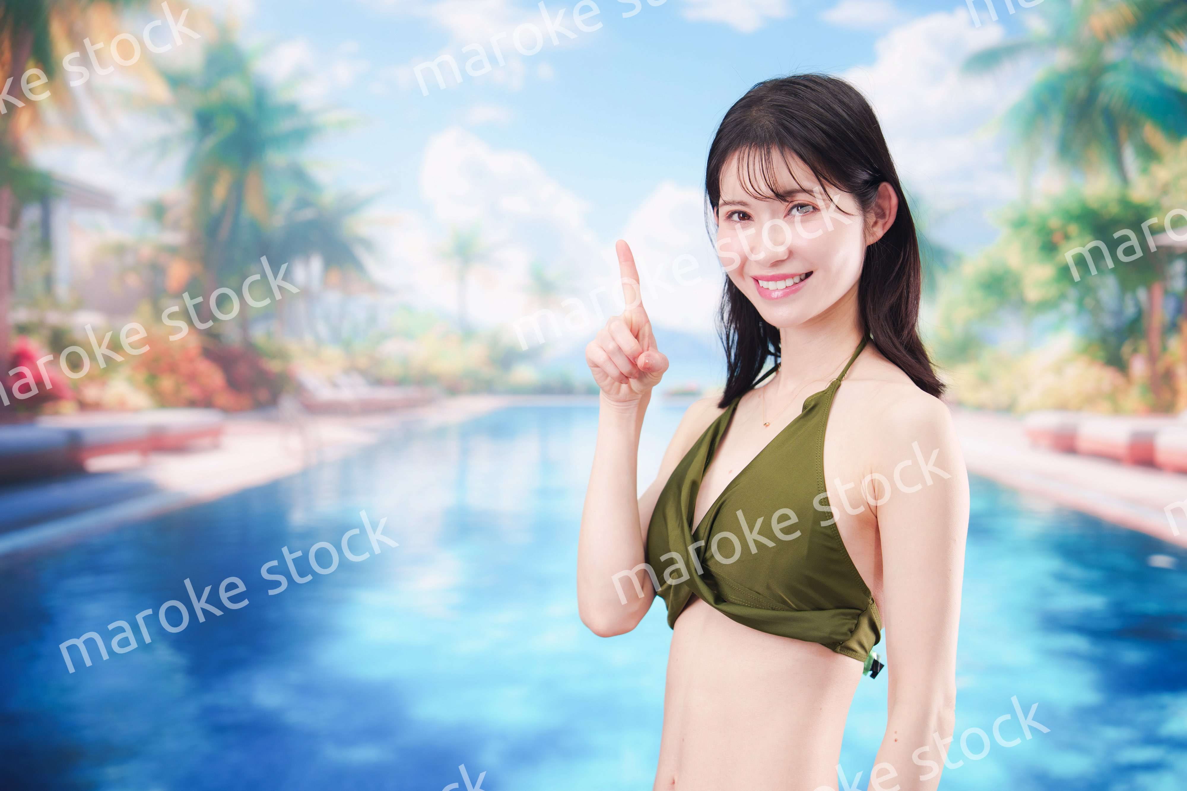 リゾートのプールで夏を楽しむ若い女性