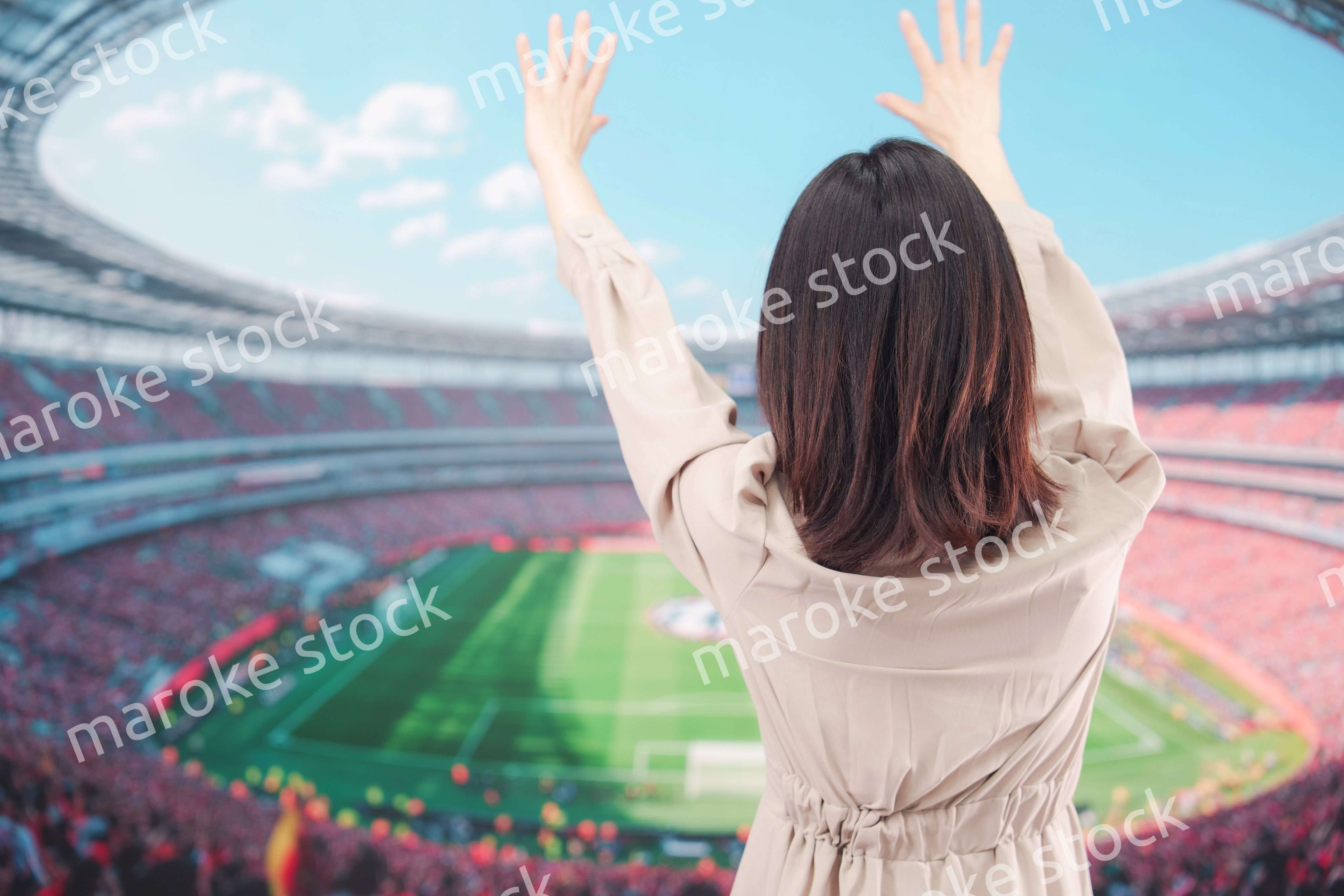 スタジアムで応援をする若い女性