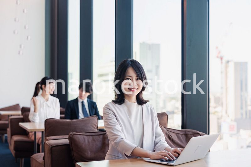 シェアオフィスでノートパソコンを使うビジネスウーマン