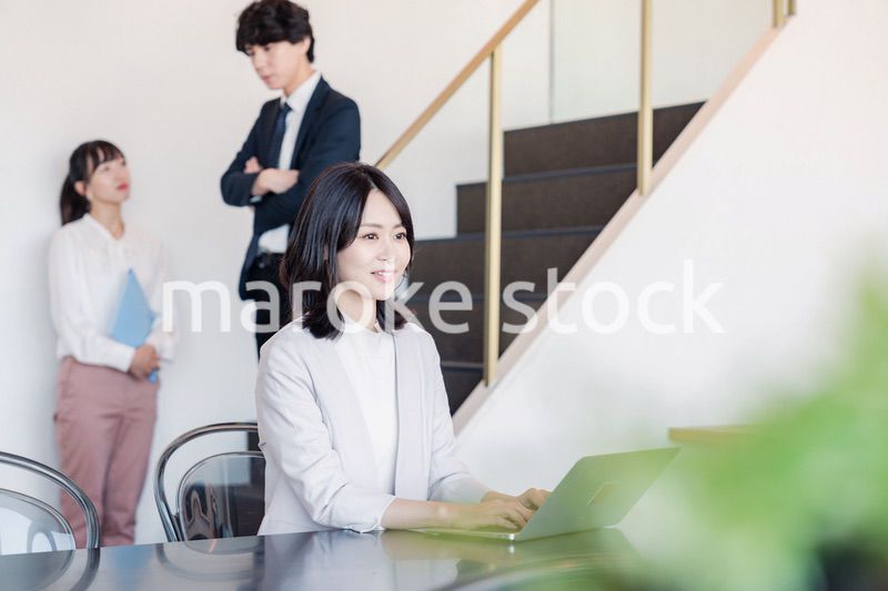 フリーアドレスのオフィスで働くビジネスウーマン