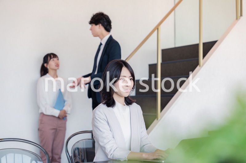 フリーアドレスのオフィスで働くビジネスウーマン