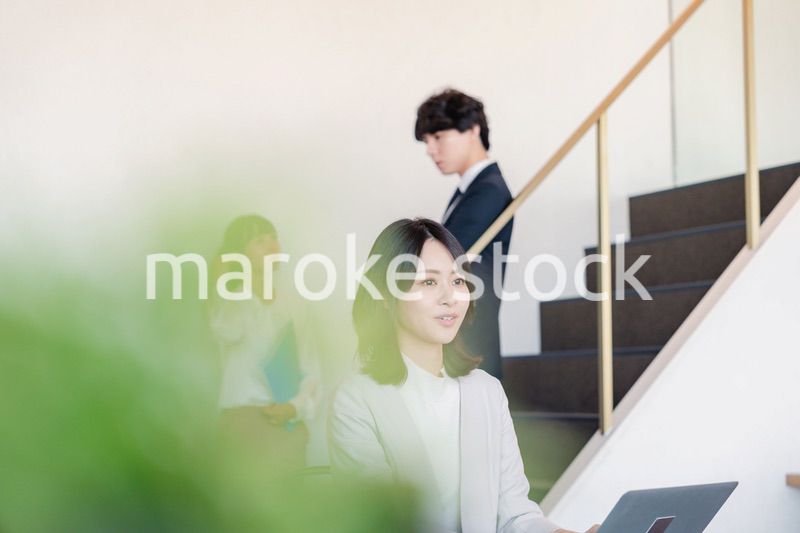 フリーアドレスのオフィスで働くビジネスウーマン