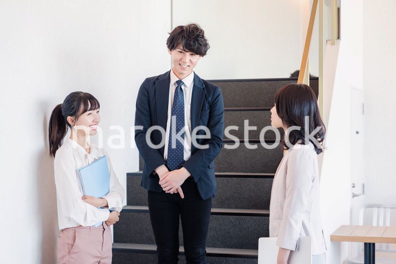 オフィスで仲良く話す若いビジネスパーソン