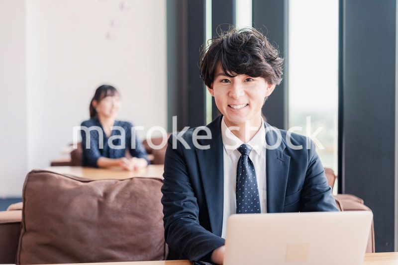 オフィスで笑顔で働くビジネスマン