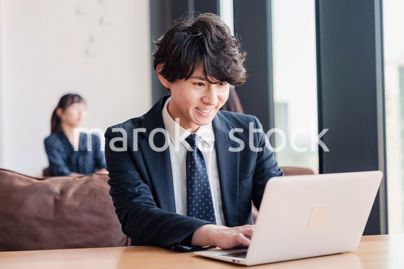 オフィスで笑顔で働くビジネスマン