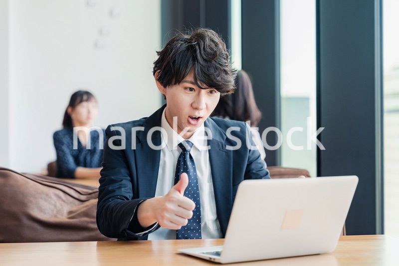 オンラインミーティングで喜ぶビジネスマン