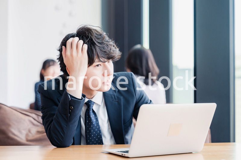 オフィスで頭を抱えるビジネスマン