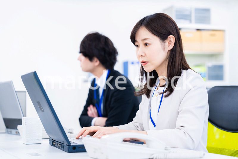 笑顔でデスクワークをする女性