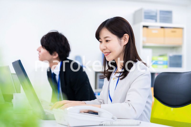 笑顔でデスクワークをする女性
