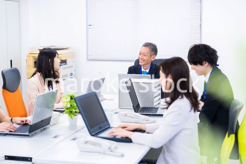 楽しくオフィスで仕事をするスタッフ