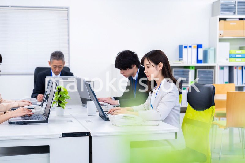 楽しくオフィスで仕事をするスタッフ