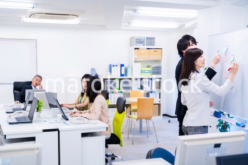 楽しくオフィスで仕事をするスタッフ