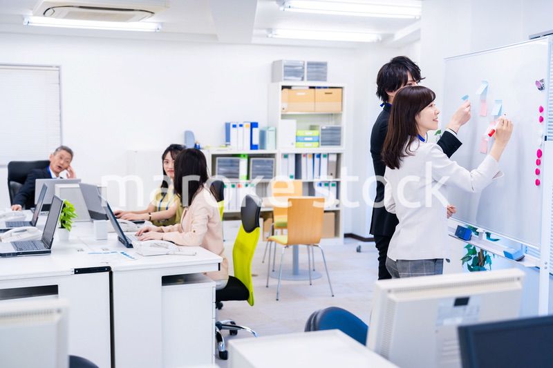 楽しくオフィスで仕事をするスタッフ