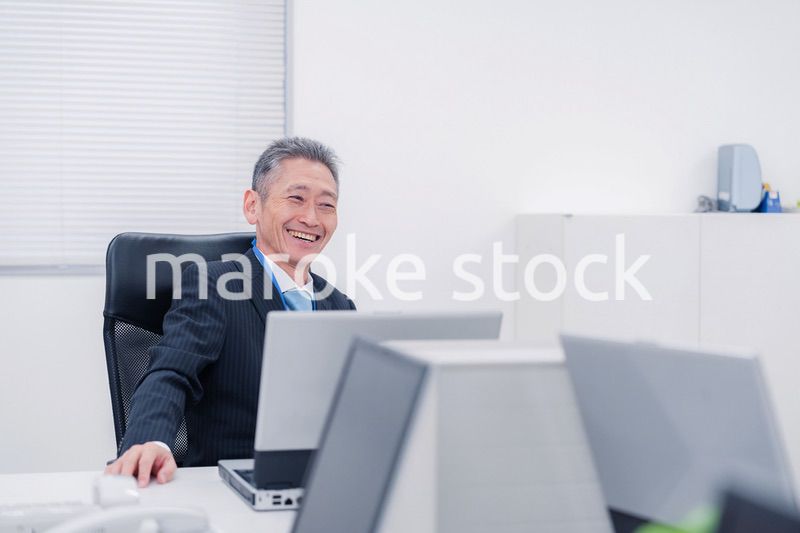 会社で自分の意見を語る管理職の男性