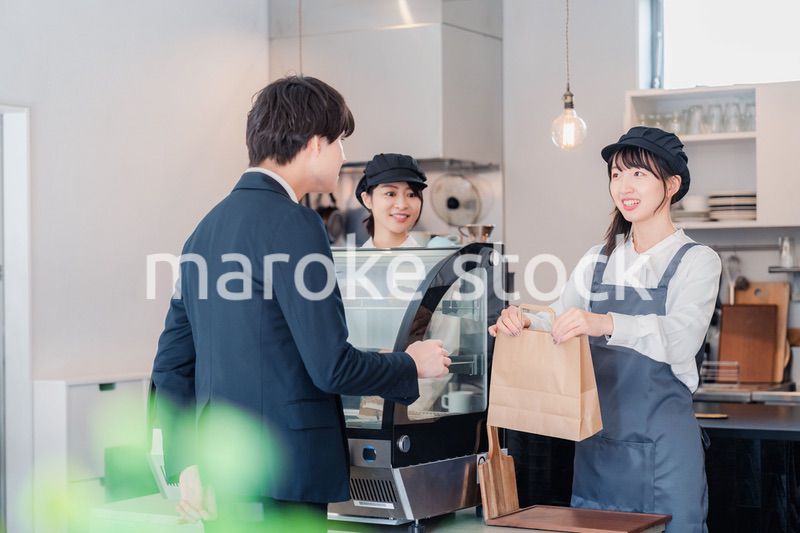 ケーキ屋で楽しく買い物をするビジネスマン