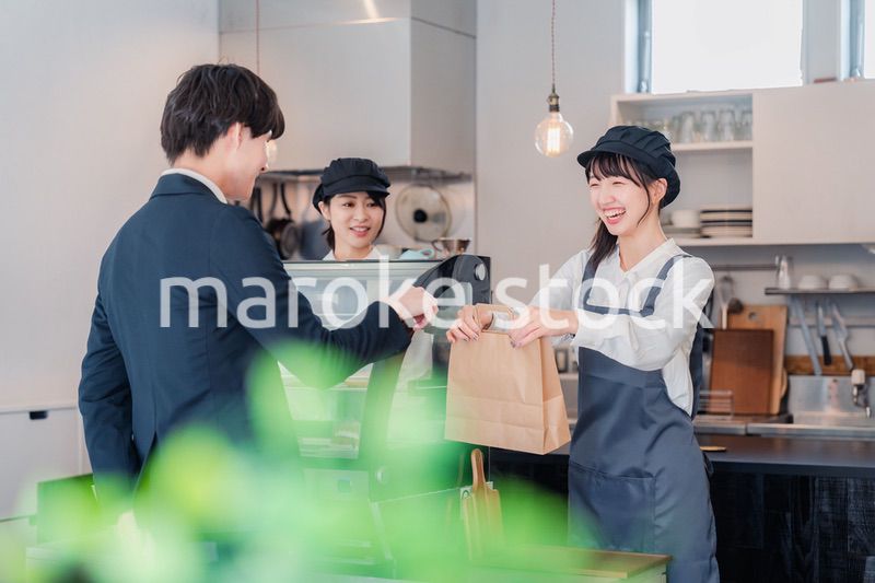 ケーキ屋で楽しく買い物をするビジネスマン