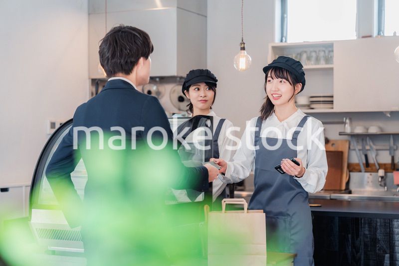 ケーキ屋で楽しく買い物をするビジネスマン