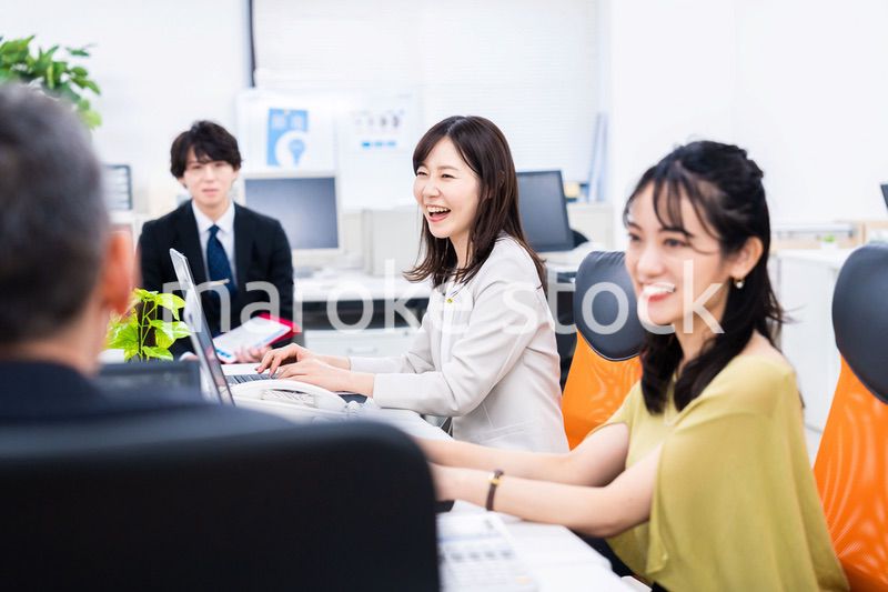 楽しくオフィスで仕事をするスタッフ