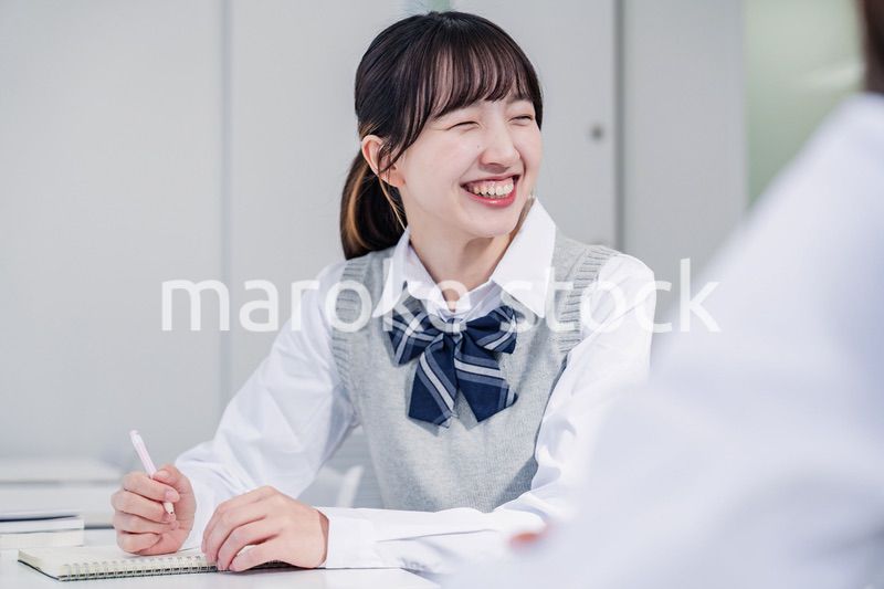 教室で休み時間に話す女子高生