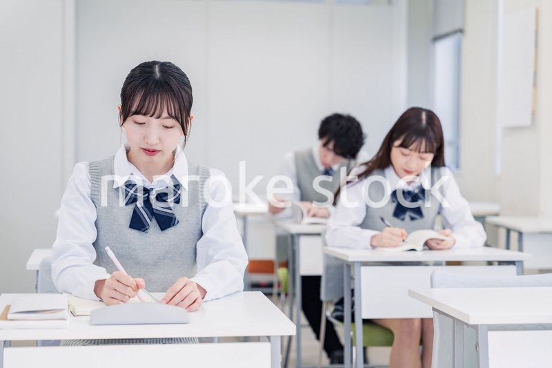 集中してノートを取る高校生