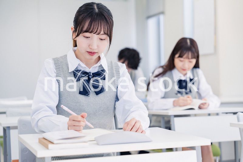 集中してノートを取る高校生