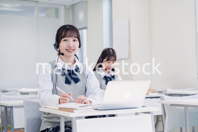 教室でノートパソコンを使う女子高生